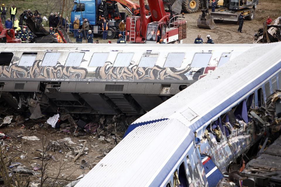 Debris of trains lie on the rail lines after a collision in Tempe, about 376 kilometres (235 miles) north of Athens, near Larissa city, Greece, Wednesday, March 1, 2023. A passenger train carrying hundreds of people, including many university students returning home from holiday, collided at high speed with an oncoming freight train before midnight on Tuesday. (AP Photo/Giannis Papanikos)