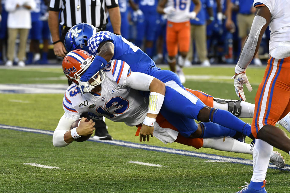 Kentucky defensive back Brandin Echols (26) brings down Florida quarterback Feleipe Franks (13) during the first half of an NCAA college football game in Lexington, Ky., Saturday, Sept. 14, 2019. (AP Photo/Timothy D. Easley)
