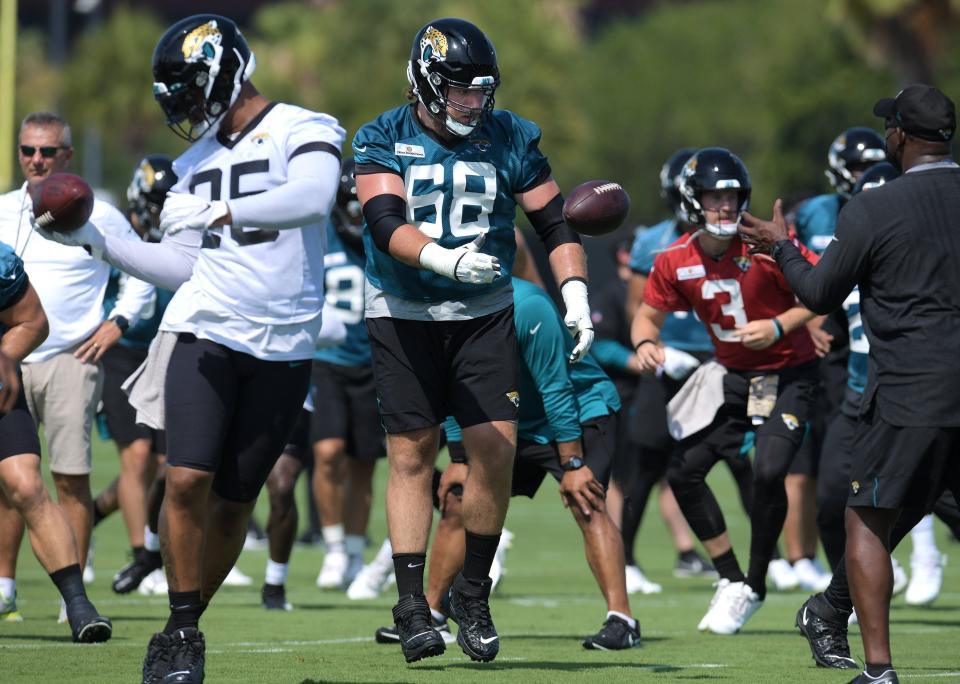 Jaguars OL (68) Andrew Norwell has the ball thrown to him as he runs through drills with the rest of his teammates during Tuesday's minicamp session. The Jacksonville Jaguars held their Tuesday morning session of the team's mandatory minicamp at the practice fields outside TIAA Bank Field, June 15, 2021. [Bob Self/Florida Times-Union]