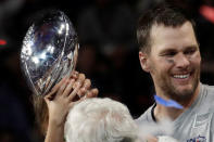 NFL Football - Super Bowl LIII - New England Patriots v Los Angeles Rams - Mercedes-Benz Stadium, Atlanta, Georgia, U.S. - February 3, 2019. New England Patriots' quarterback Tom Brady celebrates alongside the Vince Lombardi Trophy after winning Super Bowl LIII. REUTERS/Mike Segar