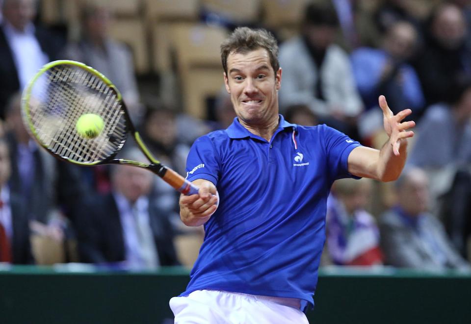 France's Richard Gasquet returns the ball to Australia's Nick Kyrgios during their single match, in the first round of the Davis Cup between France and Australia, in La Roche sur Yon, western France, Friday Jan. 31, 2014.(AP Photo/Remy de la Mauviniere)