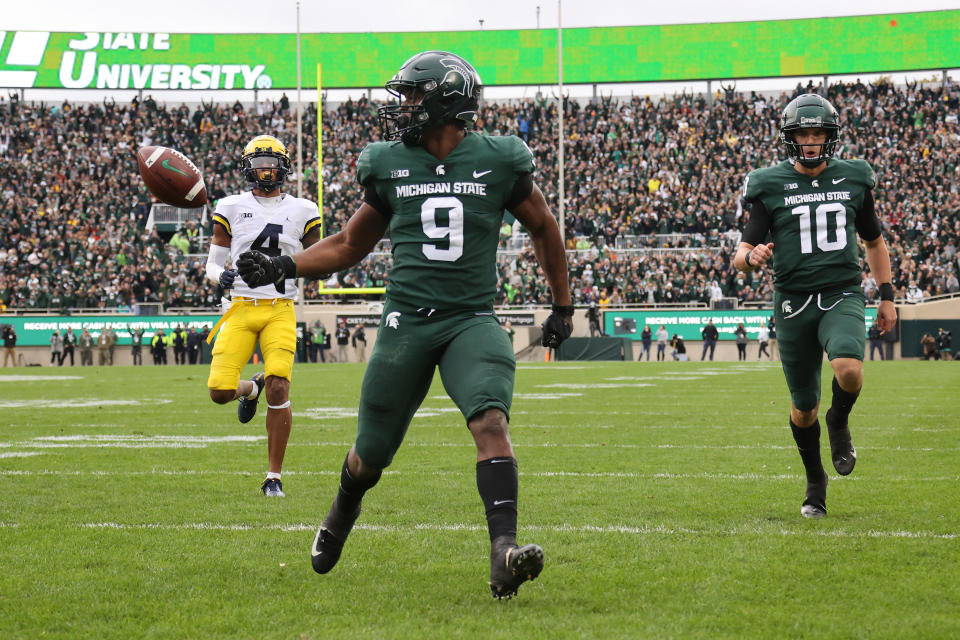 Kenneth Walker III #9 of the Michigan State Spartans scores a first half touchdown in front of Vincent Gray #4 of the Michigan Wolverines at Spartan Stadium on Oct. 30, 2021 in East Lansing, Michigan. Gregory Shamus/Getty Images