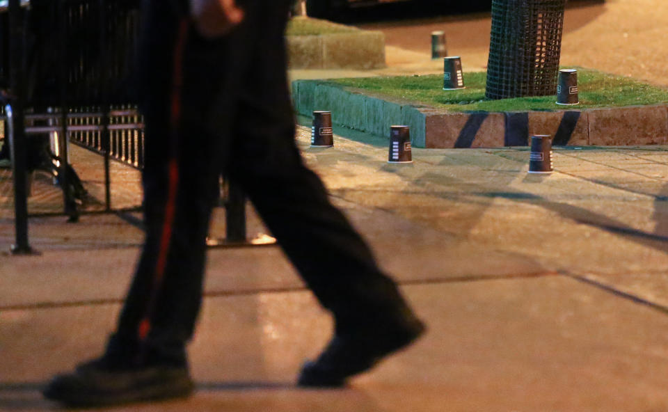 <p>A police officer walks past evidence marked with coffee cups after a mass shooting in Toronto, Canada, July 23, 2018. (Photo: Chris Helgren/Reuters) </p>