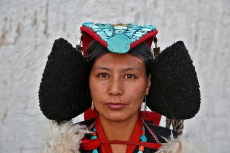 Phunchok Angmo, 33, a mathematics teacher, poses for a photograph at Thiksey monastery, near Leh, the largest town in the region of Ladakh, nestled high in the Indian Himalayas, India September 28, 2016. When asked how living in the world's fastest growing major economy had affected life, Angmo replied: "The children here no longer care about the culture and they spend less time talking to each other. They spend their free time on laptops." REUTERS/Cathal McNaughton