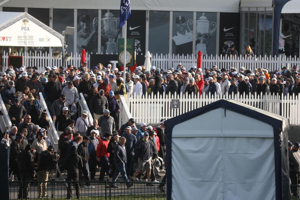 A large crowd is bottle necked near the merchandise tent as the public is finally allowed to come in to the PGA Championship at Oak Hill Country Club in Pittsford after a frost delayed play.