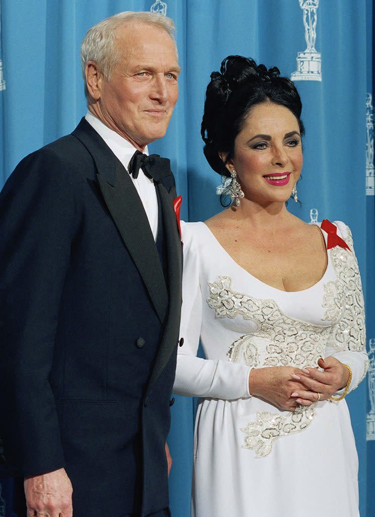 Elizabeth Taylor (with Paul Newman) proudly wore a red ribbon for AIDS awareness at the 64th Annual Academy Awards in 1992. (Photo: AP Photo/Bob Galbraith)