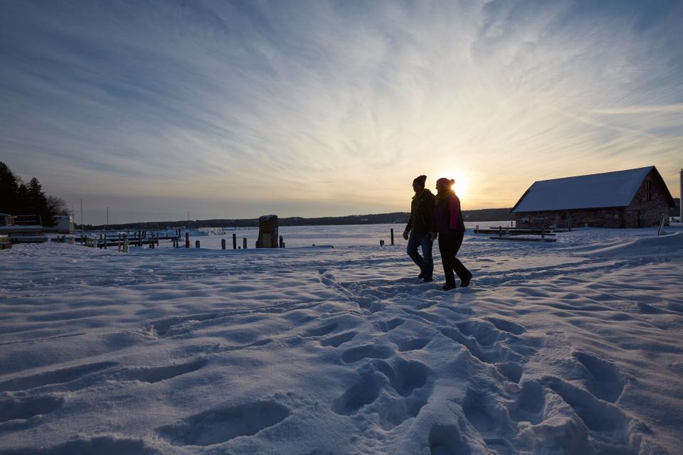 A couple enjoys a sunset hike at Ephraim's Anderson Dock in winter.