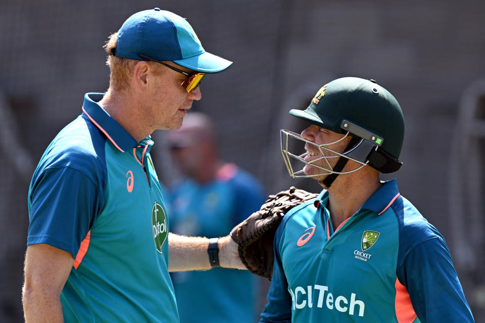 Australian coach Andrew McDonald (L) interacts with batsman David Warner (R) in the nets during a practice session at the Melbourne Cricket Ground (MCG) in Melbourne on December 24, 2023, ahead of the second cricket Test match against Pakistan. (Photo by William WEST / AFP) / -- IMAGE RESTRICTED TO EDITORIAL USE - STRICTLY NO COMMERCIAL USE -- (Photo by WILLIAM WEST/AFP via Getty Images)