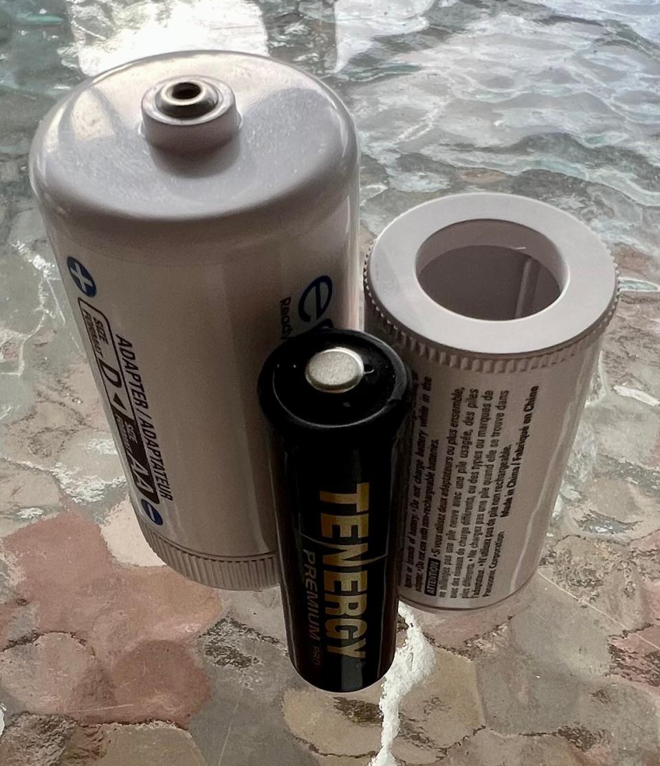 A AA rechargeable battery, center, can take the place of D cells or C cells by slipping into sleeves (D size at left; C size, right) designed to hold the AA battery in place.