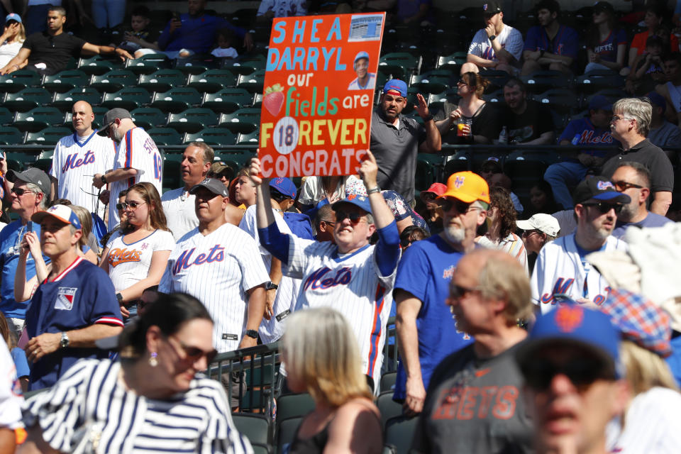 A fan displays a sign congratulating former New York Mets outfielder Darryl Strawberry during ceremony to retire his number before a baseball game, Saturday, June 1, 2024, in New York. (AP Photo/Noah K. Murray)