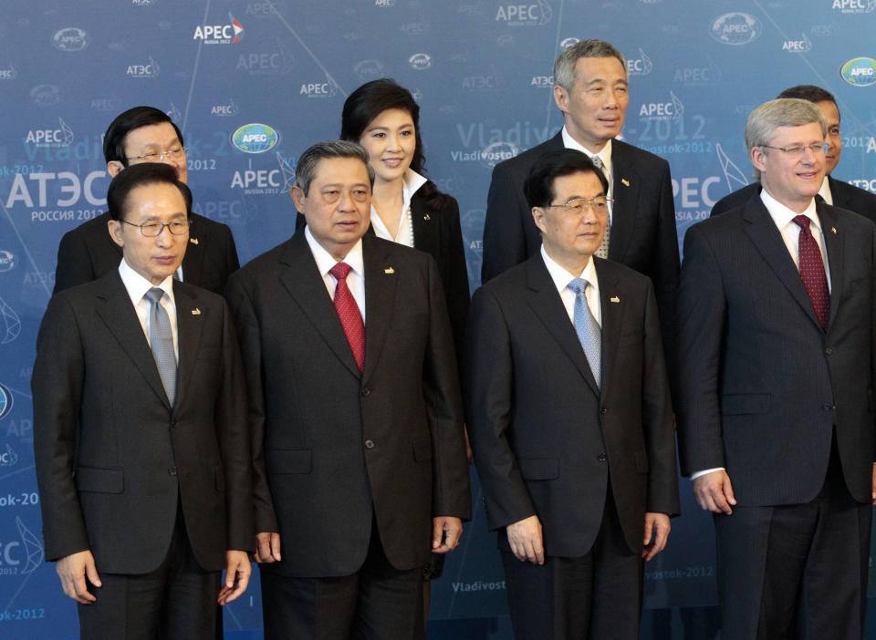 Leaders, from left, South Korean President Lee Myung-bak, Vietnamese President Truong Tan Sang (obscured), Indonesian President Susilo Bambang Yudhoyono, Thailand's Prime Minister Yingluck Shinawatra, Chinese President Hu Jintao, Singapore Prime Minister Lee Hsien Loong, Canadian Prime Minister Stephen Harper and Peruvian President Ollanta Humala (obscured) pose for a group photo on the final day of the APEC summit in Vladivostok, Russia, Sunday, Sept. 9, 2012. (AP Photo/Ahn Young-joon)