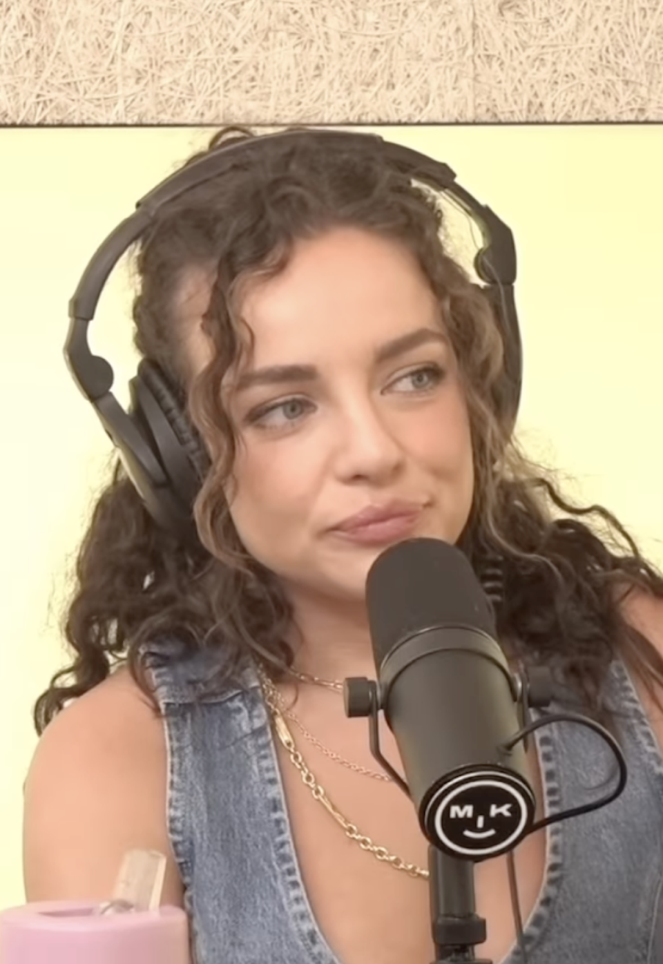 Abbie Chatfield pictured with headphones and podcast microphone 