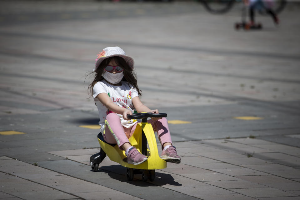 ANKARA, TURKEY - MAY 13: Kids enjoy outdoor time at Tunali Hilmi Street after children under 14 years across Turkey allowed to leave their homes, remaining within walking distance and wearing masks, on May 13 between 11 a.m. and 3 p.m. local time, in Ankara, Turkey on May 13, 2020. Turkey on Wednesday eased coronavirus (Covid-19) restrictions for young people under 14 years old. (Photo by Binnur Ege Gurun Kocak/Anadolu Agency via Getty Images)