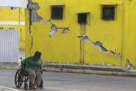 <p>A man sits in his wheelchair backdropped by a building damaged in a massive earthquake, in Juchitan, Oaxaca state, Mexico Friday, Sept. 8, 2017. One of the most powerful earthquakes ever to strike Mexico has hit off its southern Pacific coast, killing at least 32 people, toppling houses, government offices and businesses. (AP Photo/Luis Alberto Cruz) </p>