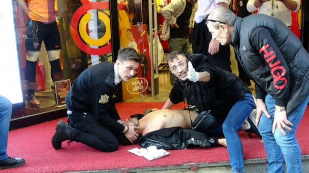 PHOTO: People attend a wounded man after an explosion in Istikla Street in central Istanbul, Nov. 13, 2022. (Ihlas News Agency via Reuters)