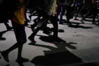 Migrants walk along a street in a caravan towards the United States, in Tapachula