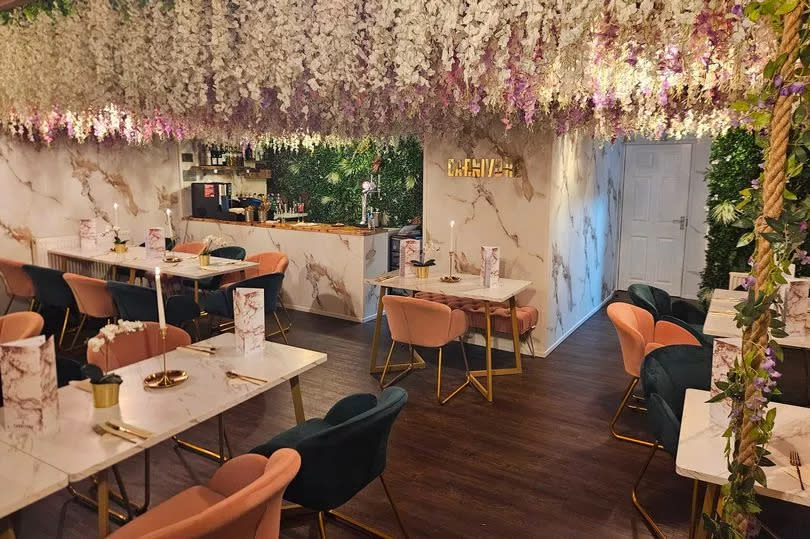 Inside Carnivore: the ceiling is adorned with blossom and the tables, chairs and decor are pretty and plush