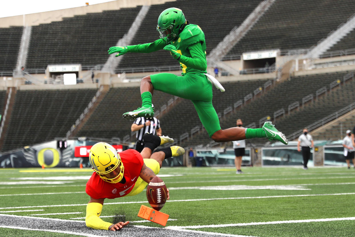 EUGENE, OREGON - MAY 01: Robby Ashford #6 of the Oregon Ducks dives to score a touchdown against Bryan Addison #13 of the Oregon Ducks on the final play of the game in the fourth quarter during the Oregon spring game at Autzen Stadium on May 01, 2021 in Eugene, Oregon. (Photo by Abbie Parr/Getty Images)