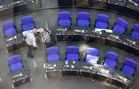 Technicians prepare the seats at the plenary hall of the German lower house of parliament (Bundestag) at the Reichstag building in Berlin, Germany, October 18, 2017. REUTERS/Hannibal Hanschke