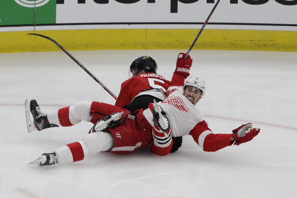 Detroit Red Wings center Dylan Larkin (71) reacts after he was checking by Chicago Blackhawks defenseman Connor Murphy (5) during the first period of an NHL hockey game in Chicago, Sunday, Jan. 5, 2020. (AP Photo/Nam Y. Huh)