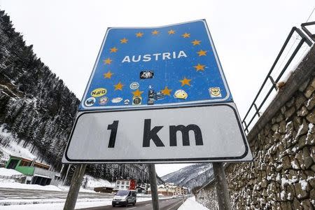 A car passes a street sign reading 'Austria' in the Italian village of Brenner on the Italian-Austrian border, March 3, 2016. REUTERS/Dominic Ebenbichler