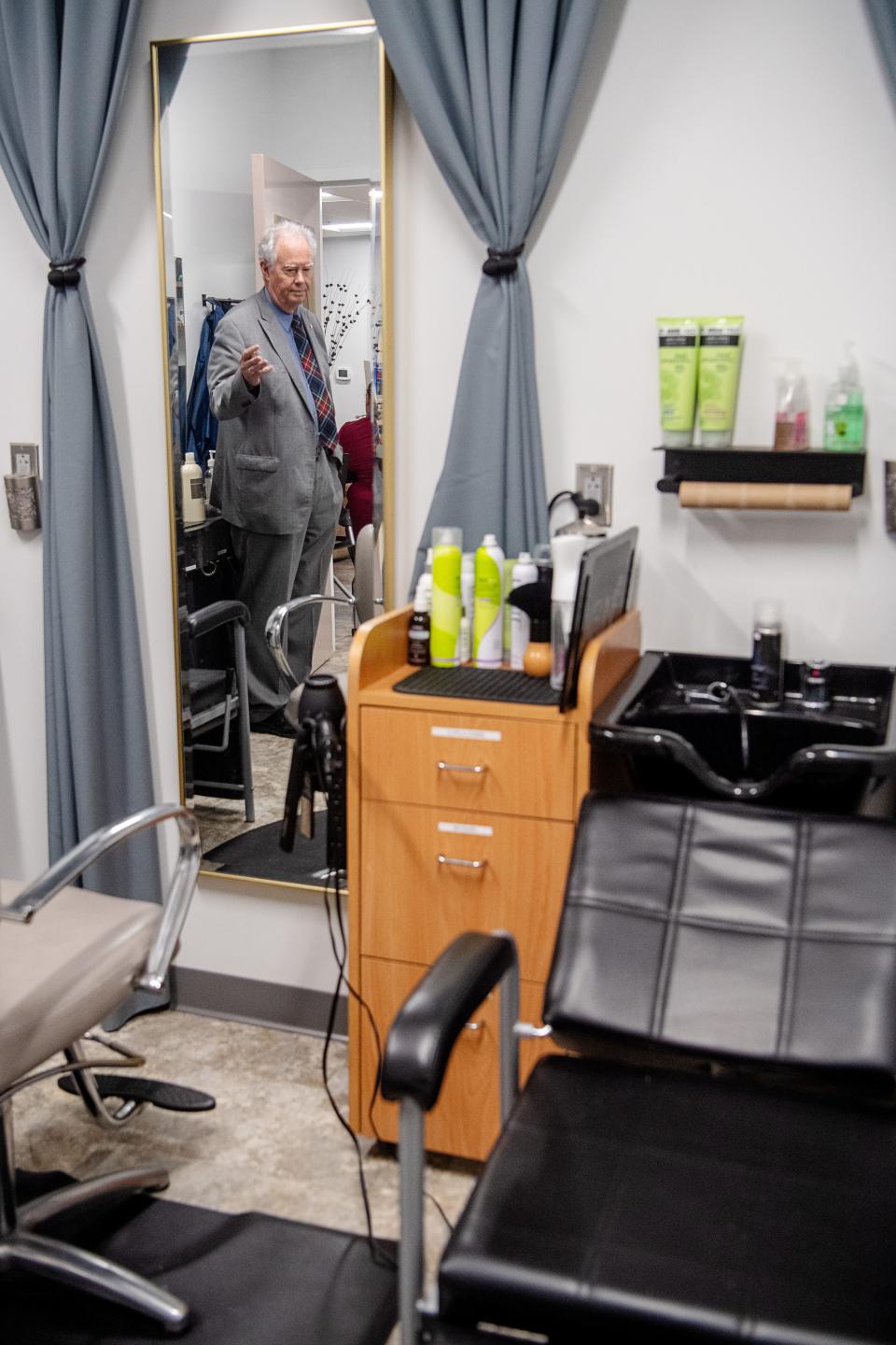 ABCCM executive director Scott Rogers is reflected in a mirror in the hair salon at Transformation Village, April 11, 2024.