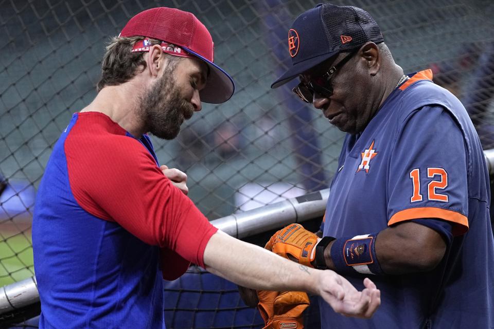 Philadelphia Phillies' Bryce Harper, left, talks with Houston Astros manager Dusty Baker Jr. (12) before a baseball game Saturday, April 29, 2023, in Houston. (AP Photo/David J. Phillip)