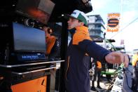 Pato O'Ward, of Mexico, stretches before a practice session for the IndyCar Grand Prix auto race at Indianapolis Motor Speedway, Friday, May 10, 2024, in Indianapolis. (AP Photo/Darron Cummings)