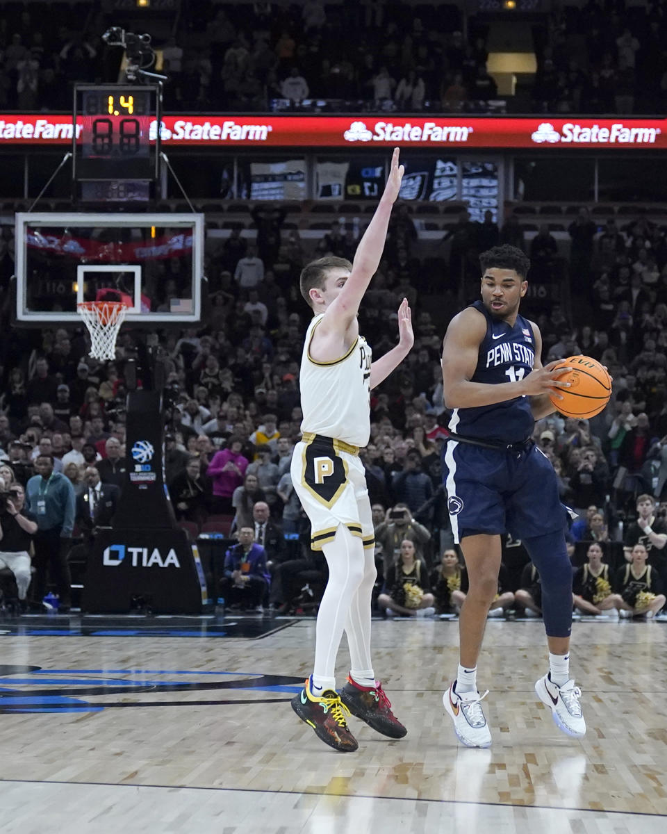 CORRECTS TO SUNDAY, MARCH 12, 2023, NOT SATURDAY, MARCH 11, 2023 - Penn State's Camren Wynter (11) travels with the ball as Purdue's Braden Smith defends, ending Penn State's comeback during the second half of an NCAA college basketball championship game at the Big Ten men's tournament, Sunday, March 12, 2023, in Chicago. Purdue won 67-65. (AP Photo/Erin Hooley)