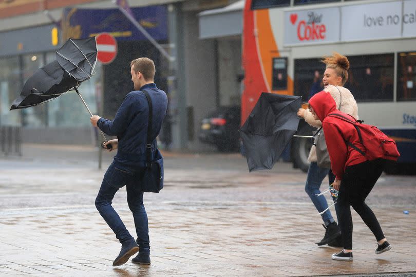 BLACKPOOL, ENGLAND - OCTOBER 20:  Students brave high winds and rain on Blackpool promenade as Britain prepares for high winds over the next two days on October 20, 2014 in Blackpool, England. Weather warnings have been by the Met Office for high winds and rain across parts of the country as as the remnants of Hurricane Gonzalo reach Britain's coast.  (Photo by Christopher Furlong/Getty Images)