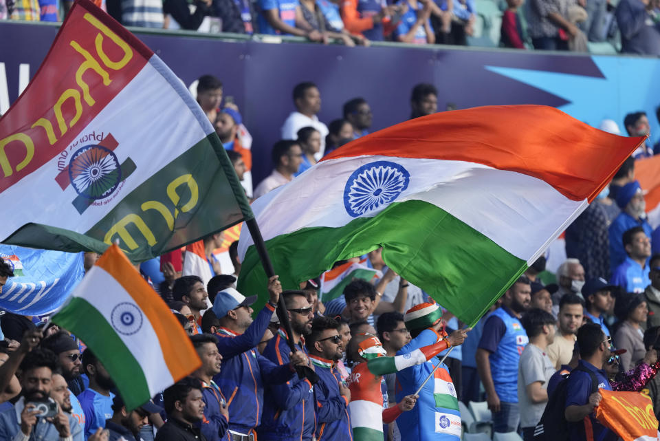 Indian fans wave flags ahead of the T20 World Cup cricket match between India and the Netherlands in Sydney, Australia, Thursday, Oct. 27, 2022. (AP Photo/Rick Rycroft)