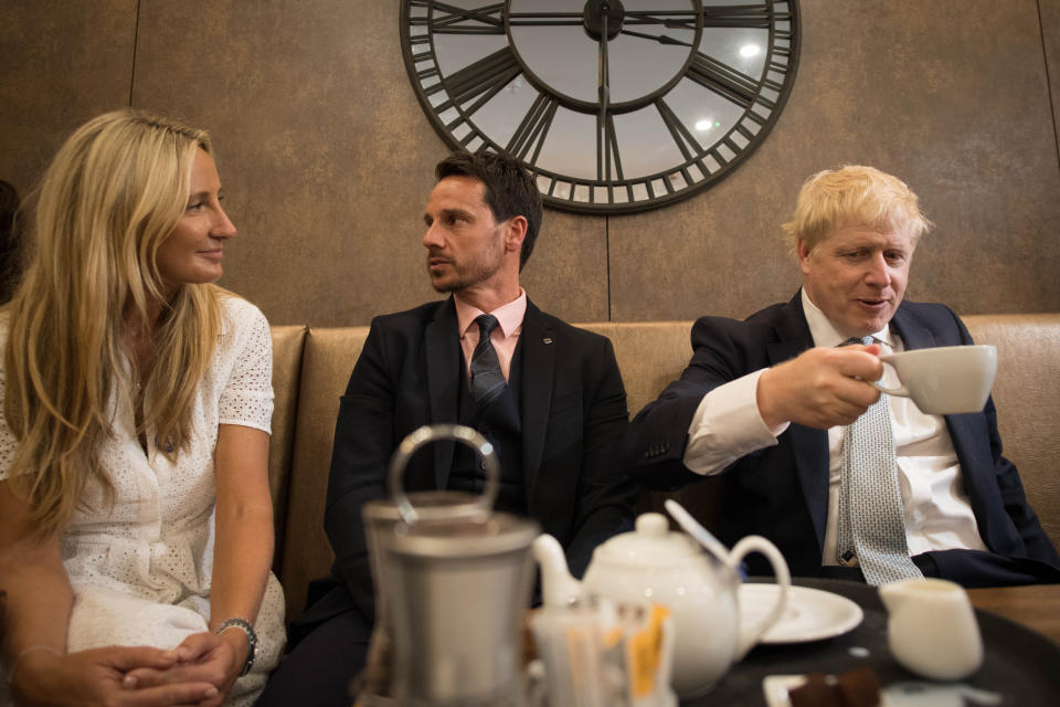 Conservative party leadership candidate Boris Johnson (right) interacts with local business people in the Munch and Wiggles cafe in Oxshott, Surrey.
