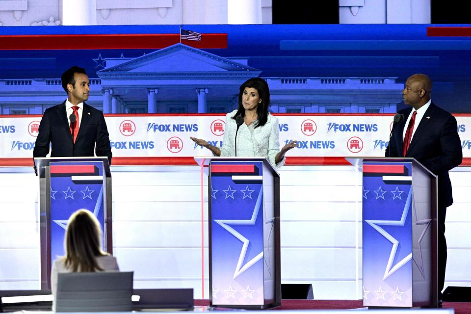 Former South Carolina Gov. Nikki Haley, center, speaks, flanked by Sen. Tim Scott and entrepreneur and author Vivek Ramaswamy, left, during the first Republican Presidential primary debate at the Fiserv Forum in Milwaukee, on Aug. 23, 2023.