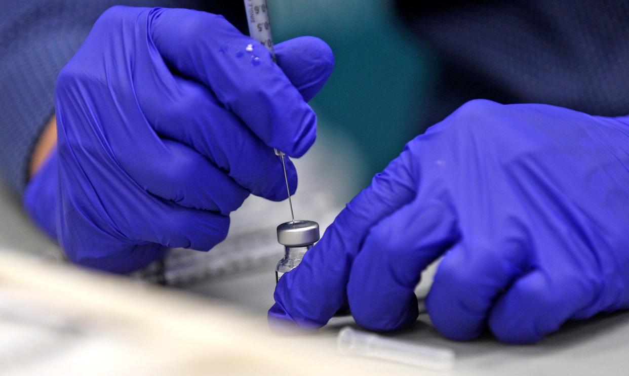 Shannon Medical Center pharmacist Carlos Robledo draws a COVID-19 vaccine shot at the vaccination center in the Sunset Mall on Thursday, March 11, 2021.