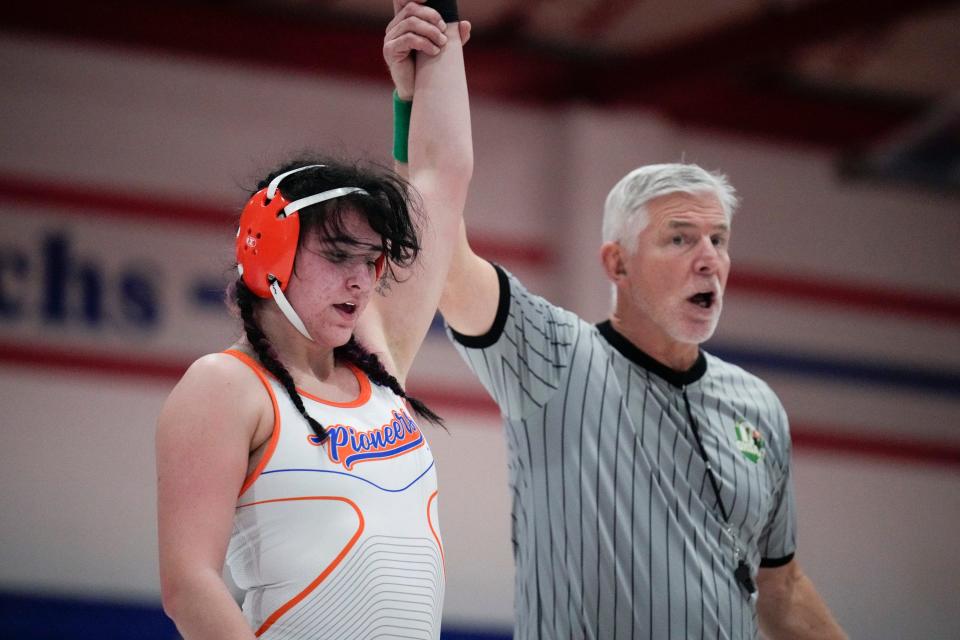 A referee raises the left arm of Olentangy Orange’s Kascidy Garren after she defeated Marysville's Aubrey Reese during the girls state duals Sunday at Marysville.