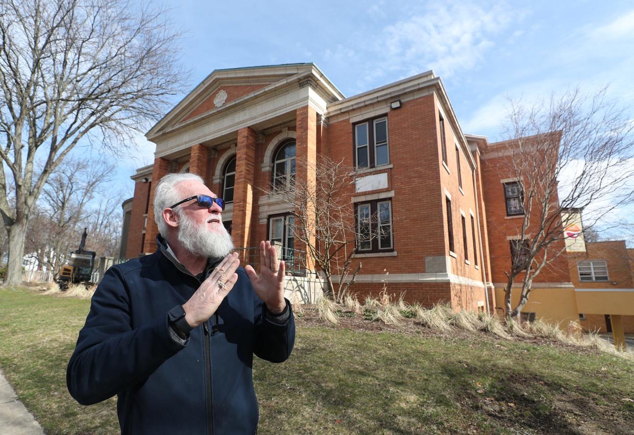 Tony Troppe talks about the beauty of the former Temple Israel, which is now the Highland Square Universal Gathering Place, HUG art center, on Thursday.