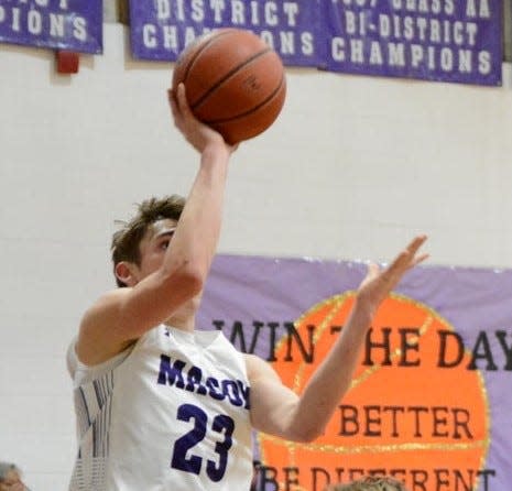 Mason High School's Brody Comey (23) lays up the ball during a District 29-2A boys basketball game in the 2021-2022 season.