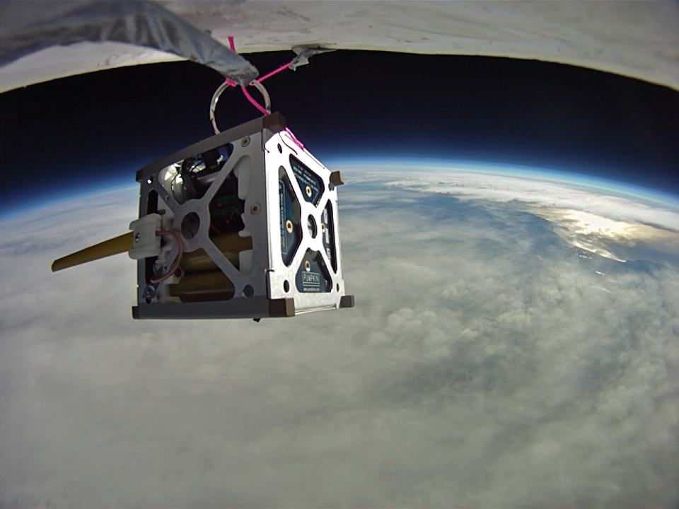 A cubesat satellite in space.