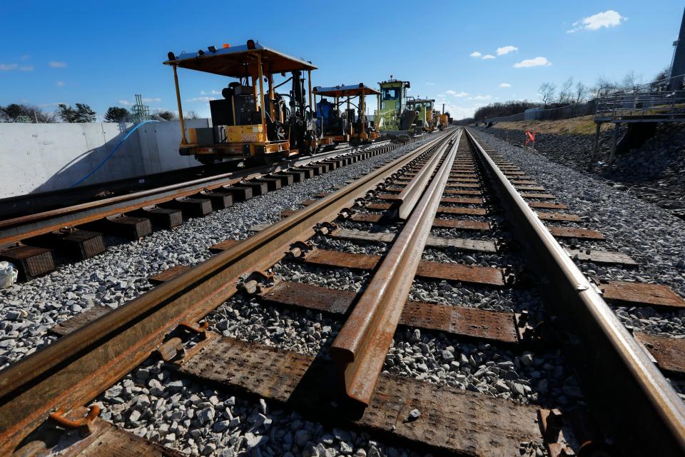 Rail beams waiting to be installed are seen on the tracks near the foundations, left, of the Church Street train station platform being constructed in New Bedford in this file photo from December 2022. This is one of two train station platforms currently under construction in New Bedford in anticipation for the commuter rail to finally make a stop in the Whaling City.