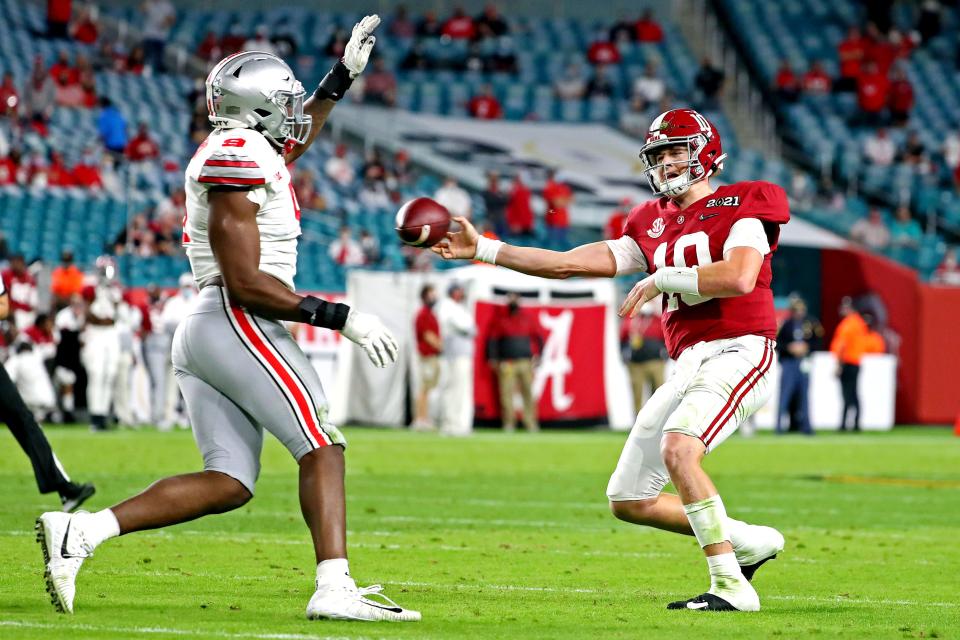 Alabama quarterback Mac Jones passes against Ohio State defensive end Zach Harrison during the College Football Playoff national championship game, Jan 11, 2021 in Miami Gardens, Fla.