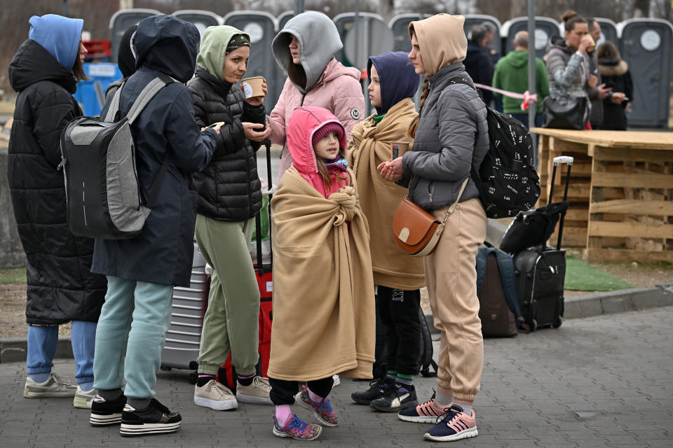 PRZEMYSL, POLAND - MARCH 29: People who have fled the war in Ukraine gather outside a temporary refugee shelter that was formerly an abandoned TESCO supermarket after being transported from the Polish Ukrainian border, on March 29, 2022 in Przemysl Poland. The Polish government has said it may spend €24 billion this year hosting refugees fleeing the war in Ukraine, and is seeking more support from the European Union. With more than 2.2 million Ukrainian refugees, Poland is now the country with the second-largest foreign refugee population after Turkey. (Photo by Jeff J Mitchell/Getty Images)