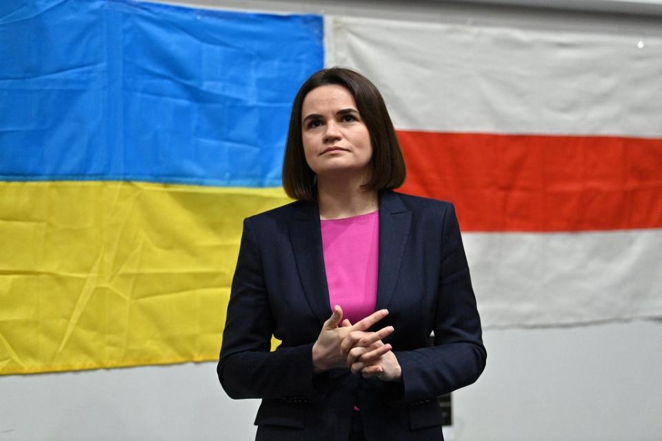 File photo: Belarus’s opposition leader Svetlana Tikhanovskaya stands in front of a national flag of Ukraine and a former national red and white flag of Belarus as before addressing Belarusian diaspora in London, 9 March 2022 (AFP via Getty Images)