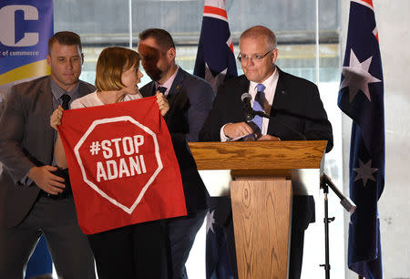 A Stop Adani protestor is removed from the stage where Australian Prime Minister Scott Morrison was making a speech at the Valley Chamber of Commerce business luncheon in Brisbane, Australia, April 8, 2019. Picture taken April 8, 2019. AAP Image/Dave Hunt/via REUTERS