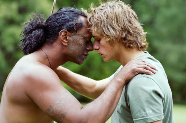 Maori man performing Hongi with male tourist