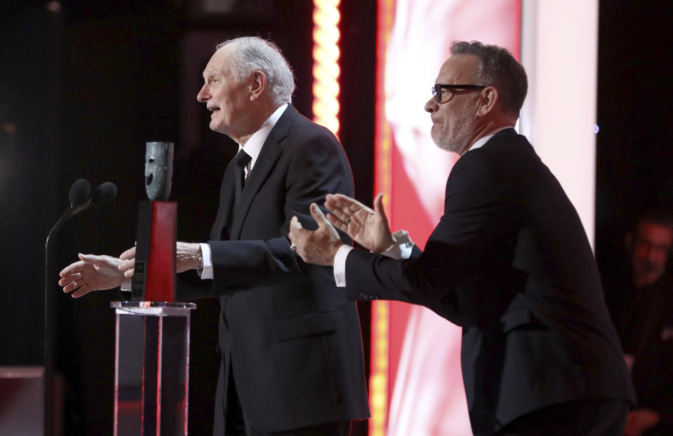 Alan Alda, left, accepts the Life Achievement award while Tom Hanks applauds at the 25th annual Screen Actors Guild Awards at the Shrine Auditorium & Expo Hall on Sunday, Jan. 27, 2019, in Los Angeles. (Photo by Matt Sayles/Invision/AP)