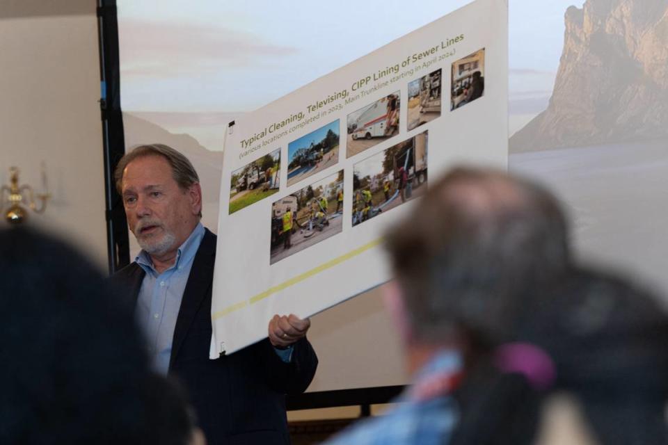 Jim Nold, senior project manager for Cahokia Heights’ engineering firm Hurst-Rosche, holds up a sign demonstrating the typical method of cleaning and inspecting sewer lines at a Cahokia Heights, Ill. town hall meeting on March 27, 2024. Nold explained the multi-million dollar project’s plan, citing the need to repair the city’s faulty sewer system. Joshua Carter/Belleville News-Democrat