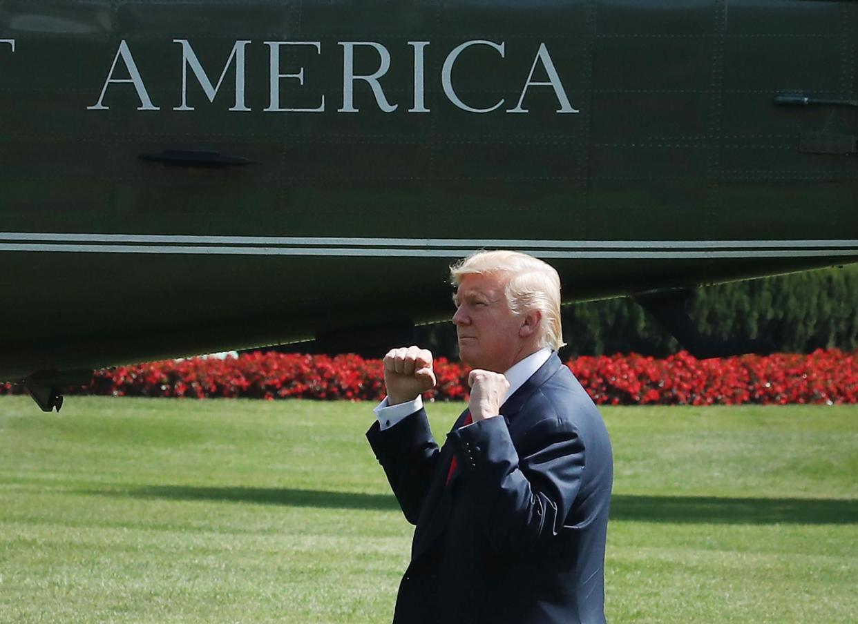 President Donald Trump gestures to a crowd gathered to watch him depart on Marine One for Bedminster: Mark Wilson/Getty Images