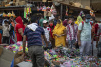 Indians crowd a wholesale market ahead of the Hindu festival of Dussehra in New Delhi, India, Saturday, Oct. 24, 2020. The Hindu festival season that draws tens and thousands of people, packed together shoulder-to-shoulder in temples, shopping districts and congregations, has lead to fears and a sense of foreboding among health experts who warn of a whole new cascade of infections, further testing India’s already battered healthcare system. The fears of such a prospect, in fact, prompted Prime Minister Narendra Modi to address the nation in a televised speech earlier this week. Pointing to Western countries, he appealed to Indians not to lower their guard during the festive season and warned people of “any laxity” that "could strain India’s health system.” (AP Photo/Altaf Qadri)