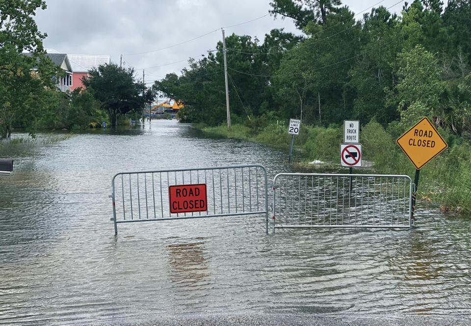 Waters from the Gulf of Mexico, driven by Hurricane Sally, flood this Pass Christian, Miss., street and threaten the homes that line it Tuesday, Sept. 15, 2020. A slow moving Hurricane Sally is expected to bring between 10 to 20 inches of rainfall to the area. (Hunter Dawkins/The Gazebo Gazette via AP)