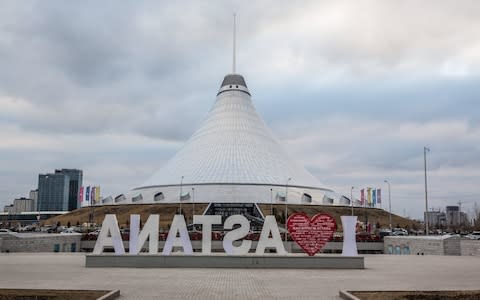 An "I love Astana" sign stands in front of the Khan Shatyr Mall designed by Norman Foster  - Credit: Taylor Weidman/Bloomberg